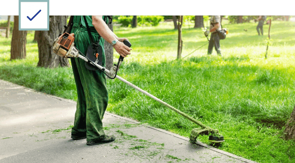 Lawn Care Worker Using a TWeed Trimmer