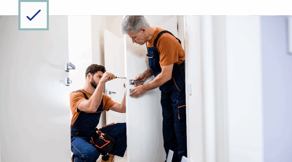 Maintenance Workers Repairing an Interior Door